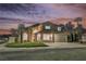 Charming two-story home with desert landscaping and a two-car garage under a beautiful evening sky at 8401 Airmont Ct, Las Vegas, NV 89128
