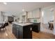 An open kitchen with a center island, stainless appliances, modern cabinets, and hardwood floors at 8401 Airmont Ct, Las Vegas, NV 89128