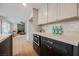 The bright kitchen features modern appliances and light cabinets, complemented by a beautiful living space at 8401 Airmont Ct, Las Vegas, NV 89128