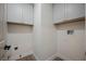 Functional laundry room with neutral walls, vinyl flooring and plenty of cabinet storage space at 8401 Airmont Ct, Las Vegas, NV 89128