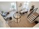A contemporary living room with hardwood floors, dining area, and a staircase with a pendant chandelier at 8401 Airmont Ct, Las Vegas, NV 89128