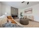 Comfortable living room with a modern fireplace, neutral decor, and lots of natural light at 8401 Airmont Ct, Las Vegas, NV 89128