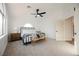The spacious main bedroom features high ceilings, a ceiling fan, a full bed, and bench at 8401 Airmont Ct, Las Vegas, NV 89128