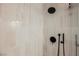Modern shower with beige tiling, black fixtures and rainfall shower head at 8401 Airmont Ct, Las Vegas, NV 89128
