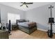 This cozy bedroom features a comfortable bed, ceiling fan, and light-filled window at 8501 W University Ave # 1002, Las Vegas, NV 89147