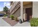 Condo entrance with rock landscaping, stairs, and decorative statue at 8501 W University Ave # 1002, Las Vegas, NV 89147