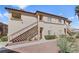 Apartment building featuring an exterior staircase and a well-maintained landscape at 8501 W University Ave # 1002, Las Vegas, NV 89147