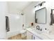 Modern bathroom features tub, shower, new vanity, and stylish mirror at 8501 W University Ave # 1042, Las Vegas, NV 89147