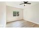 Bedroom featuring wood-look floors, window, and fan at 8501 W University Ave # 1042, Las Vegas, NV 89147