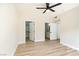 Bright bedroom features wood-look floors, a ceiling fan, and access to a walk-in closet and ensuite at 8501 W University Ave # 1042, Las Vegas, NV 89147