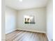 Cozy bedroom features wood-look floors and a bright window at 8501 W University Ave # 1042, Las Vegas, NV 89147