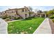 Exterior shot of a building with covered stairs leading to upper units and green lawn at 8501 W University Ave # 1042, Las Vegas, NV 89147