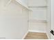 Bright and tidy walk-in closet with white shelving and wood-look floors at 8501 W University Ave # 1042, Las Vegas, NV 89147