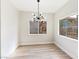 Charming dining room boasts modern chandelier and large window views at 8501 W University Ave # 1042, Las Vegas, NV 89147