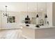 Bright kitchen with white cabinets, modern pendant lights, and an adjacent dining area at 8501 W University Ave # 1042, Las Vegas, NV 89147