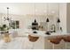 Bright kitchen with white cabinets, modern pendant lights, and an adjacent dining area at 8501 W University Ave # 1042, Las Vegas, NV 89147