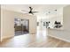 Open-concept living area showcases light wood floors and a kitchen with a breakfast bar at 8501 W University Ave # 1042, Las Vegas, NV 89147