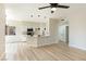 Open-concept living area showcasing light wood floors and a kitchen with a breakfast bar at 8501 W University Ave # 1042, Las Vegas, NV 89147