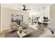 Bright living room featuring wood floors, modern ceiling fan, and open concept to the kitchen at 8501 W University Ave # 1042, Las Vegas, NV 89147