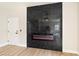 Bright living room features a modern fireplace and light wood floors at 8501 W University Ave # 1042, Las Vegas, NV 89147