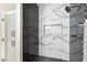 Walk-in shower features herringbone and marble tile design with niche at 8501 W University Ave # 1042, Las Vegas, NV 89147