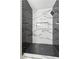 Walk-in shower features herringbone and marble tile design with niche at 8501 W University Ave # 1042, Las Vegas, NV 89147