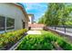 This backyard features a compact lawn area, a small patio, and some minimal landscaping, providing a simple outdoor space at 9360 Canalino Dr, Las Vegas, NV 89134