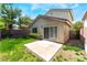 A fenced in backyard features a concrete patio and some grass with minimal landscaping at 9360 Canalino Dr, Las Vegas, NV 89134