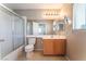 A bathroom features a shower/tub, a single sink, a toilet and a large mirror at 9360 Canalino Dr, Las Vegas, NV 89134