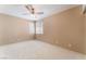 A spacious bedroom features neutral walls, white carpet and a ceiling fan at 9360 Canalino Dr, Las Vegas, NV 89134