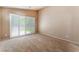 Cozy bedroom with neutral walls, carpet, and sliding glass doors with plantation shutters at 9360 Canalino Dr, Las Vegas, NV 89134