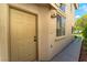 Close-up of a well-maintained home entrance with a classic door and exterior lighting at 9360 Canalino Dr, Las Vegas, NV 89134