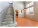 Spacious entryway featuring staircase, kitchen view, hardwood floors, and plantation shutters at 9360 Canalino Dr, Las Vegas, NV 89134