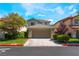 Charming two-story home featuring well-maintained landscaping, a two-car garage, and a welcoming entrance at 9360 Canalino Dr, Las Vegas, NV 89134