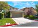 Inviting home exterior with a spacious driveway, tidy landscaping, and attached two-car garage at 9360 Canalino Dr, Las Vegas, NV 89134