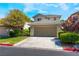 Charming two-story home with a tile roof, manicured landscaping, and a two car garage at 9360 Canalino Dr, Las Vegas, NV 89134