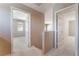 Upstairs hallway features neutral walls and white carpet with bedrooms visible through open doors at 9360 Canalino Dr, Las Vegas, NV 89134