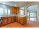 Well-lit kitchen features wood cabinets, stainless steel appliances, and a pass-through to the living area at 9360 Canalino Dr, Las Vegas, NV 89134