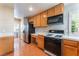Functional kitchen features stainless steel appliances, wood cabinets, and an adjacent laundry area at 9360 Canalino Dr, Las Vegas, NV 89134