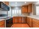 Well-equipped kitchen boasting wood cabinetry, laminate floors, and stainless-steel appliances at 9360 Canalino Dr, Las Vegas, NV 89134