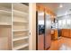 Kitchen featuring stainless steel refrigerator, wood cabinets, tile backsplash, range, and access to pantry at 9360 Canalino Dr, Las Vegas, NV 89134
