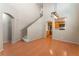 Open-concept living space features wood floors, staircase, and an archway leading to the kitchen at 9360 Canalino Dr, Las Vegas, NV 89134