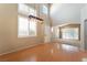 Bright living room with wood floors, modern light fixture, high ceilings, and large windows with shutters at 9360 Canalino Dr, Las Vegas, NV 89134