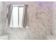 Luxurious walk-in shower featuring marble surround, bench seating, and a window at 9360 Canalino Dr, Las Vegas, NV 89134