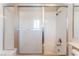 A shower/tub combo features white tile and a sliding glass door at 9360 Canalino Dr, Las Vegas, NV 89134