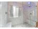 Luxurious walk-in shower featuring marble surround, bench seating, glass surround and door at 9360 Canalino Dr, Las Vegas, NV 89134