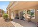 Covered patio with tiled floor offers outdoor living space with sliding doors and a view of desert landscaping at 9445 January Dr, Las Vegas, NV 89134