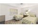 Bedroom with shutters, neutral decor, wood-look tile floors and twin beds at 9445 January Dr, Las Vegas, NV 89134