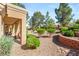 Landscaped front yard with desert landscaping and brick accents for added curb appeal at 9445 January Dr, Las Vegas, NV 89134
