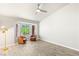 Bright living room featuring tile floors, a ceiling fan and a bay window with lovely outdoor views at 9445 January Dr, Las Vegas, NV 89134